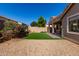 Backyard featuring low-maintenance desert landscaping and a small artificial lawn at 8758 W Hayward Ave, Glendale, AZ 85305