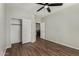Bedroom featuring hardwood floors, a ceiling fan, a closet, and a view into a separate room at 8758 W Hayward Ave, Glendale, AZ 85305