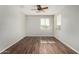An airy bedroom featuring wood floors and natural light from two windows at 8758 W Hayward Ave, Glendale, AZ 85305