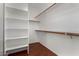 Walk-in closet with built-in shelving and wooden rods for ample storage space at 8758 W Hayward Ave, Glendale, AZ 85305