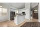 Open kitchen features white cabinetry, stainless steel appliances, and breakfast bar at 8758 W Hayward Ave, Glendale, AZ 85305