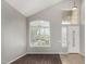 Bright and airy foyer featuring hardwood floors, large windows with shutters, and a soaring vaulted ceiling at 8758 W Hayward Ave, Glendale, AZ 85305