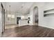 Open floor plan from living room into eat-in kitchen with bar and white cabinetry at 8758 W Hayward Ave, Glendale, AZ 85305