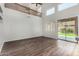 Bright living room with high ceilings, access to patio, and hardwood floors at 8758 W Hayward Ave, Glendale, AZ 85305
