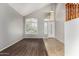 Bright and airy foyer featuring hardwood floors, large windows with shutters, and a soaring vaulted ceiling at 8758 W Hayward Ave, Glendale, AZ 85305