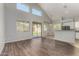 Open floor plan featuring living room leading to patio and eat-in kitchen with bar at 8758 W Hayward Ave, Glendale, AZ 85305