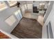 An open-concept floor plan featuring wood floors and a kitchen with granite counters at 8758 W Hayward Ave, Glendale, AZ 85305
