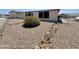 Front yard features gravel landscaping and a tidy shrub at 8840 E Sunland Ave # 142, Mesa, AZ 85208