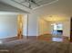 Spacious living room with an open floor plan, neutral colors, and sliding glass doors to the outdoor space at 8840 E Sunland Ave # 142, Mesa, AZ 85208