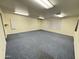 Large living room features blue carpet, neutral walls, multiple lighting fixtures and two windows at 8840 E Sunland Ave # 142, Mesa, AZ 85208
