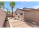 Quaint backyard complete with beige exterior, a patio and a palm tree at 8884 E Arizona Park Pl, Scottsdale, AZ 85260