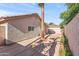 A quaint backyard is complete with partial concrete, beige exterior, and a palm tree at 8884 E Arizona Park Pl, Scottsdale, AZ 85260