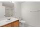 Bright bathroom featuring tile floors, white walls, updated vanity, and a shower at 8884 E Arizona Park Pl, Scottsdale, AZ 85260