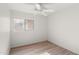Bedroom featuring laminate floors, white walls, ceiling fan, and a window at 8884 E Arizona Park Pl, Scottsdale, AZ 85260