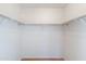 A spacious walk-in closet with laminate flooring and ample shelving for storage at 8884 E Arizona Park Pl, Scottsdale, AZ 85260
