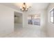 Bright dining room with white tile flooring and a modern chandelier at 8884 E Arizona Park Pl, Scottsdale, AZ 85260