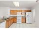 Bright kitchen with white appliances, oak cabinets, and granite countertops at 8884 E Arizona Park Pl, Scottsdale, AZ 85260