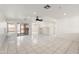 Bright and airy living room with white tile flooring, a ceiling fan, and sliding glass doors at 8884 E Arizona Park Pl, Scottsdale, AZ 85260