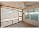 A screened in porch features concrete flooring, a ceiling fan, and view of the outdoors at 8884 E Arizona Park Pl, Scottsdale, AZ 85260