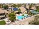Aerial view of a beautiful backyard pool and patio area, enhanced by solar panels on the roof at 10794 S Coolwater Dr, Goodyear, AZ 85338