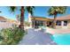 Inviting backyard pool area with lush tropical landscaping and lounge seating at 10794 S Coolwater Dr, Goodyear, AZ 85338