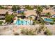 Aerial view of a private backyard pool and palm trees, fenced for security, with solar panels at 10794 S Coolwater Dr, Goodyear, AZ 85338