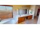Bright bathroom features a soaking tub, double sink vanity and a large window at 10794 S Coolwater Dr, Goodyear, AZ 85338