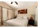 Cozy bedroom with a queen sized bed, warm neutral walls, and large windows for ample natural light at 10794 S Coolwater Dr, Goodyear, AZ 85338