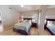 Comfortable bedroom with a wooden bed frame, soft quilt, and a bright window at 10794 S Coolwater Dr, Goodyear, AZ 85338