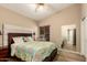 Comfortable bedroom features a cozy bed, soft lighting, and a mirror at 10794 S Coolwater Dr, Goodyear, AZ 85338