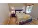 Bedroom with a wooden bed frame, soft quilt, and a bright window at 10794 S Coolwater Dr, Goodyear, AZ 85338