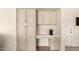 Convenient built-in desk area with ample storage and stylish tile backsplash for added functionality at 10794 S Coolwater Dr, Goodyear, AZ 85338
