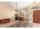 Open entryway with tiled floor and warm neutral paint, adjacent to a sitting room at 10794 S Coolwater Dr, Goodyear, AZ 85338