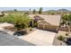 Inviting home with a three-car garage, tile roof, mature landscaping, and a spacious driveway at 10794 S Coolwater Dr, Goodyear, AZ 85338