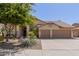 Charming single-story home with a well-maintained yard, desert landscaping, and a two-car garage at 10794 S Coolwater Dr, Goodyear, AZ 85338