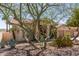 Charming home with desert landscaping, a two-car garage, and a well-manicured yard at 10794 S Coolwater Dr, Goodyear, AZ 85338