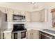 Well-equipped kitchen featuring modern appliances, white subway tile backsplash, and plenty of cabinet space at 10794 S Coolwater Dr, Goodyear, AZ 85338