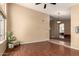 Spacious living room with laminate floors, neutral paint, and a view into the entry and Gathering room at 10794 S Coolwater Dr, Goodyear, AZ 85338