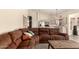 Open living room flows into the kitchen, features a large sectional sofa, and cozy decor at 10794 S Coolwater Dr, Goodyear, AZ 85338