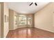 Inviting living room featuring gleaming laminate wood floors, neutral paint, and bright windows at 10794 S Coolwater Dr, Goodyear, AZ 85338