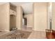 Spacious living room boasts tile floors, neutral tones, and high ceilings, creating an inviting atmosphere at 10794 S Coolwater Dr, Goodyear, AZ 85338