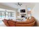 Spacious living room with fireplace and views of the pool area at 10794 S Coolwater Dr, Goodyear, AZ 85338