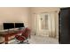 Home office with a wooden desk, two monitors, and a comfortable leather chair near a bright window at 10794 S Coolwater Dr, Goodyear, AZ 85338