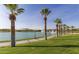 Scenic pond view shows manicured landscaping, a paved walking path and water features at 10794 S Coolwater Dr, Goodyear, AZ 85338