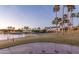 Scenic pond view shows lush tropical foliage, manicured landscaping and walking path at 10794 S Coolwater Dr, Goodyear, AZ 85338