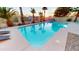 Backyard pool with palm trees and lounge chairs create a relaxing outdoor oasis for entertaining at 10794 S Coolwater Dr, Goodyear, AZ 85338