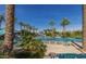 Community pool offers lounge seating, tropical foliage and water park features at 10794 S Coolwater Dr, Goodyear, AZ 85338
