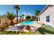 Backyard pool with palm trees, lounge chairs, and patio create an outdoor oasis for entertaining at 10794 S Coolwater Dr, Goodyear, AZ 85338
