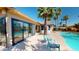 Backyard pool with palm trees and chairs create a relaxing outdoor oasis for entertaining at 10794 S Coolwater Dr, Goodyear, AZ 85338