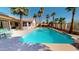 Backyard pool with palm trees, chairs, and patio area create a relaxing outdoor oasis at 10794 S Coolwater Dr, Goodyear, AZ 85338